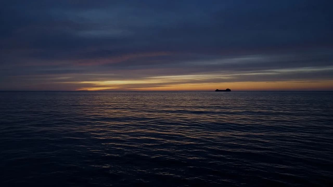 Ocean horizon with a distant ship silhouette